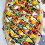 How to make Caprese Pizza with cherry tomatoes, mozzarella, basil and optional balsamic drizzle. Use store-bought pizza dough or make your own below!