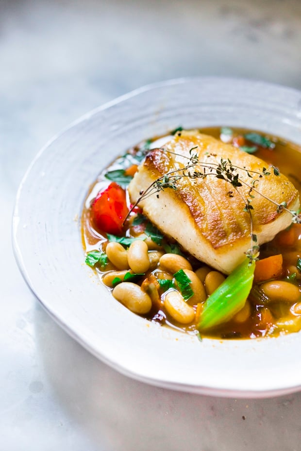 20 BEST FISH RECIPES | Pan Seared Sea Bass over a savory white bean stew. 