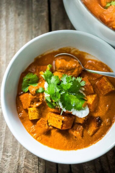 This fall-inspired recipe for Butternut Squash Tikka Masala can be made with chickpeas or chicken. The fragrant tomato coconut sauce is infused with Indian spices. A healthy, delicious vegetarian dinner recipe, perfect for fall!