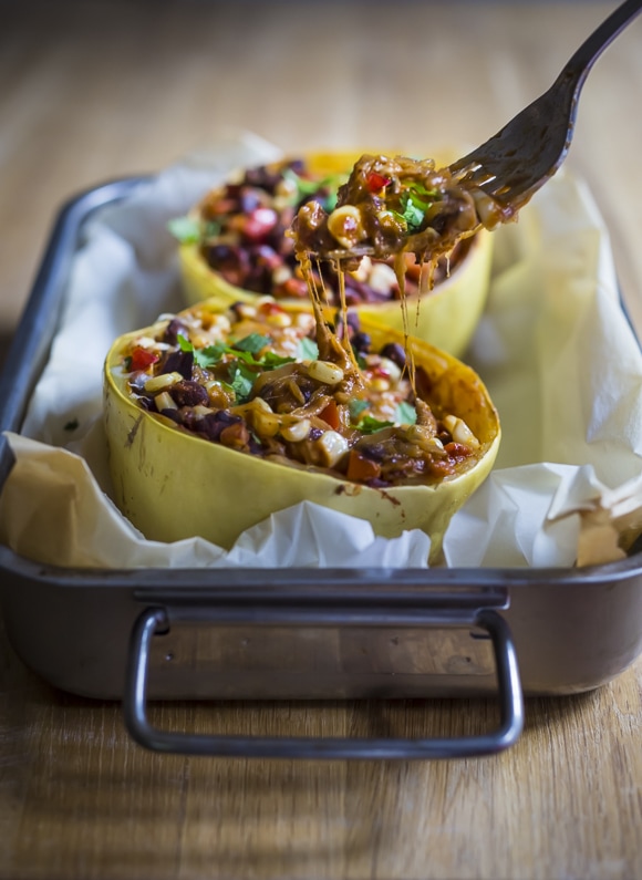 Enchilada Stuffed Spaghetti Squash with black beans, cilantro, corn and bell pepper --keep it vegan or add cheese | www.feastingathome.com