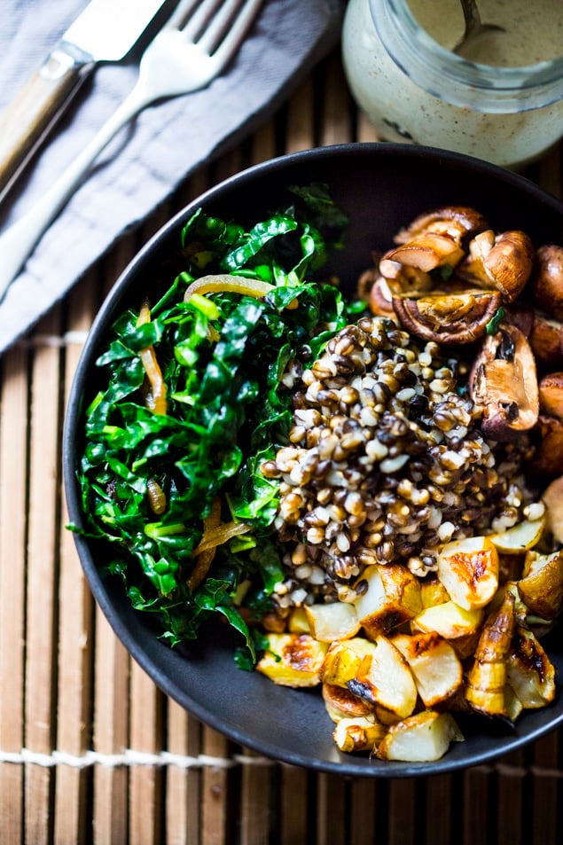This Roasted Sunchoke and Black Nile Barley Bowl, with kale, mushrooms and parsnips & a Zaatar spiced Tahini Sauce is perfect for fall! Vegan and Nutritious!