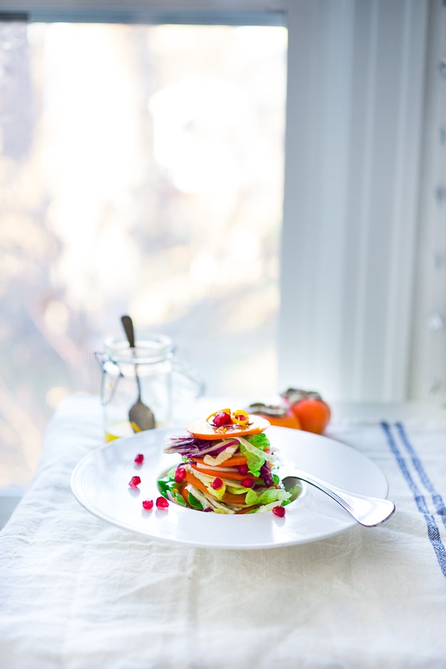 Butter Lettuce Salad with persimmons, shaved fennel, pomegranate seeds, and a bright citrus dressing. Perfect for the holiday Table! Vegan and Gluten-free | #persimmon #feastingathome #butterlettucesalad #vegansalad #salad #holidaysalad #persimmonsalad #persimmonrecipe #christmasrecipes 