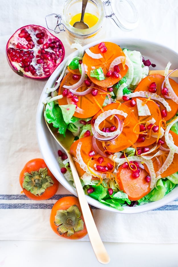 Butter Lettuce Salad with persimmons, shaved fennel, pomegranate seeds, and a bright citrus dressing. Perfect for the holiday Table! Vegan and Gluten-free | #persimmon #feastingathome #butterlettucesalad #vegansalad #salad #holidaysalad #persimmonsalad #persimmonrecipe #christmasrecipes 