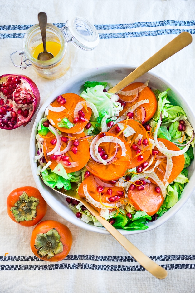 Butter Lettuce Salad with persimmons, shaved fennel, pomegranate seeds, and a bright citrus dressing. Perfect for the holiday Table! Vegan and Gluten-free | #persimmon #feastingathome #butterlettucesalad #vegansalad #salad #holidaysalad #persimmonsalad #persimmonrecipe #christmasrecipes 