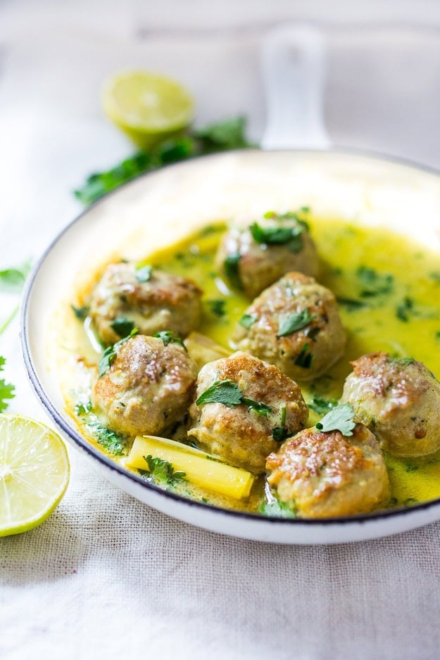 turkey meatballs in a pan with Thai coconut sauce with lemongrass and fresh cilantro.