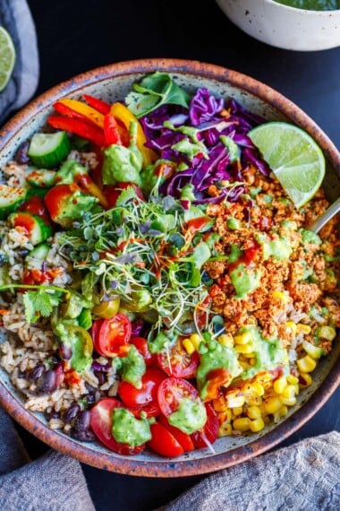 A burrito bowl with sofritas, rice, black beans, fresh veggies, avocado sauce.