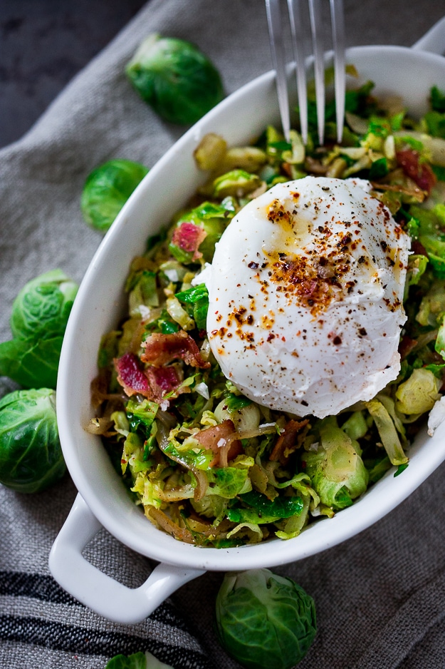 A delicious low-carb breakfast- Brussels sprouts and bacon hash topped with soft pillowy poached eggs. Bacon is optional. See recipe notes for alternatives! 
