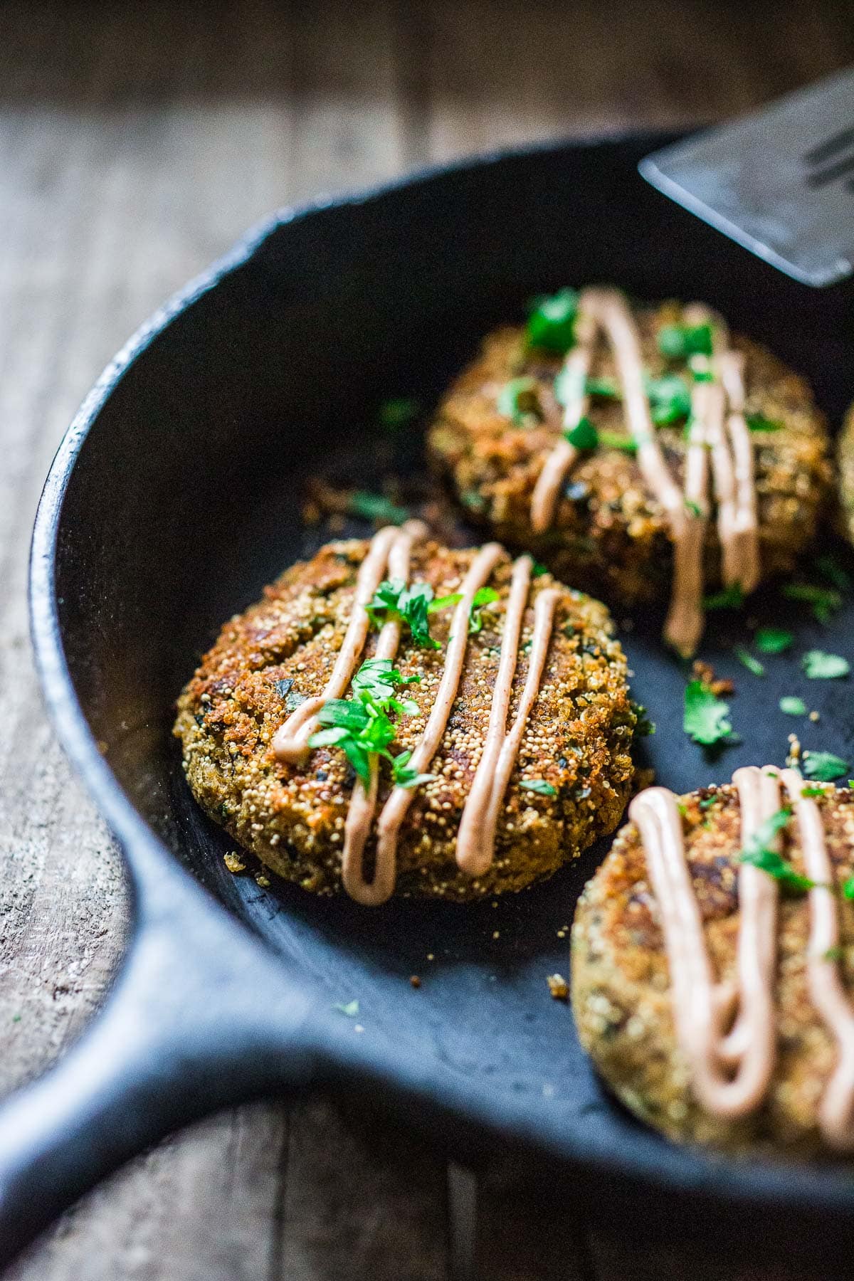 Amaranth patties, made with lentils and kale, are drizzled with a vegan chipotle aioli.