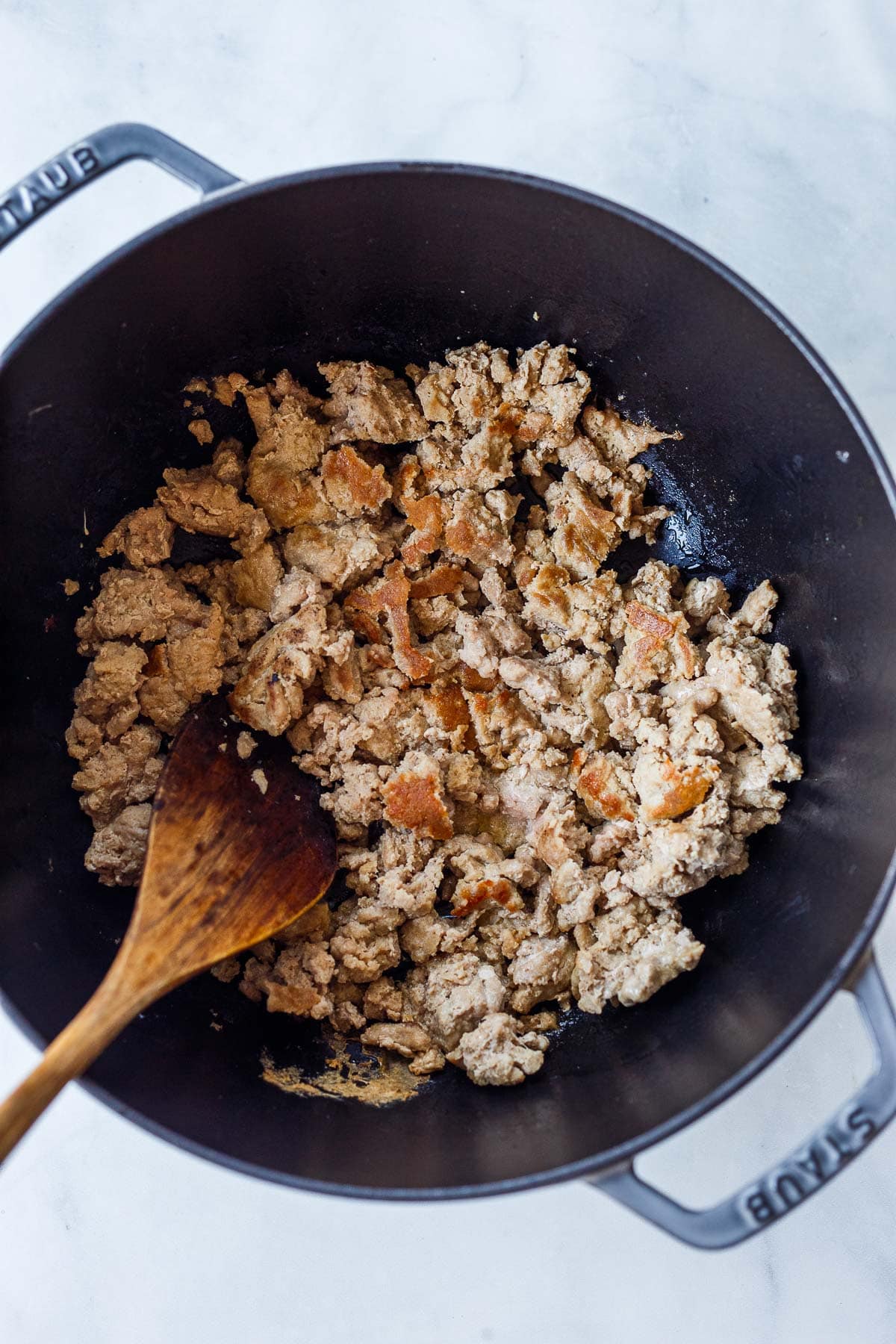 Dutch oven with browned ground turkey.
