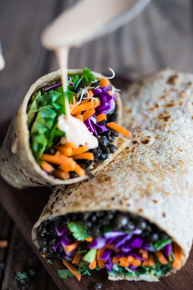 Spicy Lentil Tahini Wrap with avocado, carrots, cabbage and the tastiest Sriracha Tahini Sauce. Vegan and Delicious! #lentilwrap