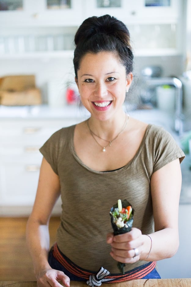 Nami Meier and her Healthy Smoked Salmon Hand rolls filled with avocado, cucumber and smoked salmon...an affordable fun way to feed a large gathering! | www.feastingathome.com