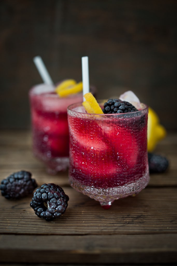 The bramble cocktail is a refreshing summer drink that combines fresh muddled blackberries, gin, lemon juice and sparkling water.