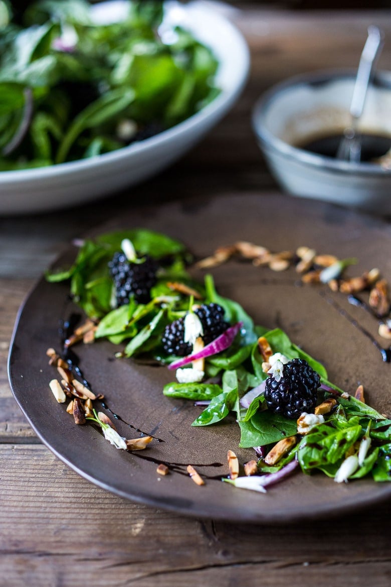 A simple recipe for Blackberry Salad with Basil and Arugula sprinkled with crumbled goat cheese, toasted almonds and a maple-balsamic dressing. A light and delicious summer salad! #blackberry #blackberrysalad