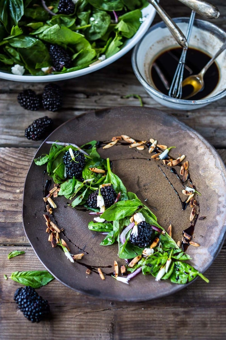 A simple recipe for Blackberry Salad with Basil and Arugula sprinkled with crumbled goat cheese, toasted almonds and a maple-balsamic dressing. A light and delicious summer salad! #blackberry #blackberrysalad