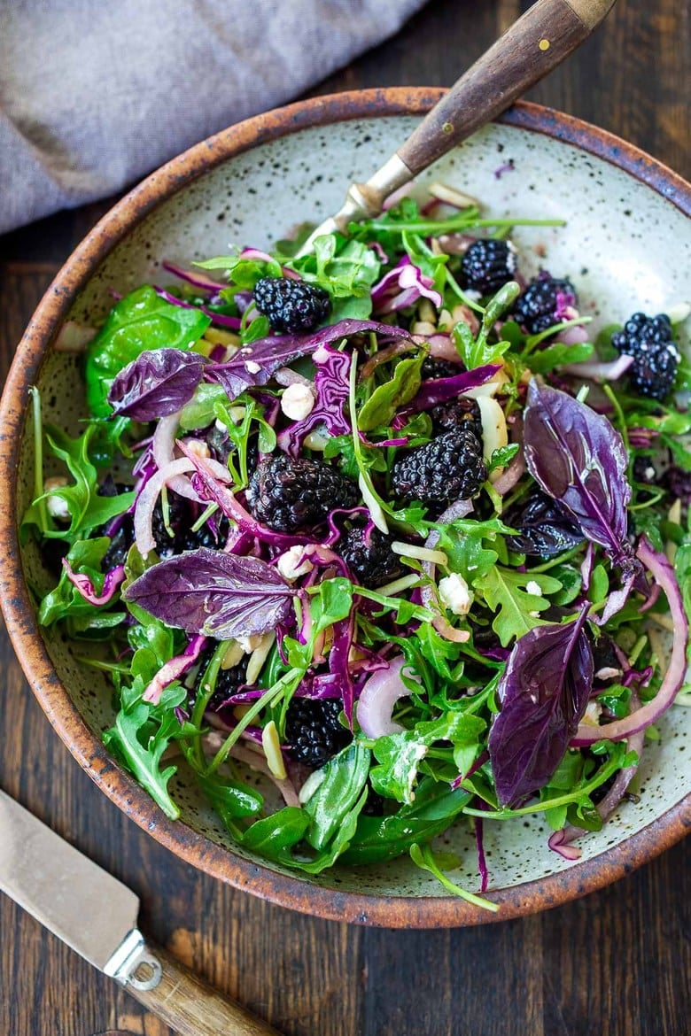 A simple recipe for Blackberry Salad with Basil and Arugula sprinkled with crumbled goat cheese, toasted almonds and a maple-balsamic dressing. A light and delicious summer salad!