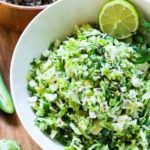 Vegan Mexican Brussel Sprout Salad with jalapeño, lime and cilantro! Serve as a "taco slaw", a side salad for grill mains or meats, or over a bowl of quinoa, with avocado, black beans, cherry tomatoes, feta...or keep it lean and vegan! This salad can be made ahead!