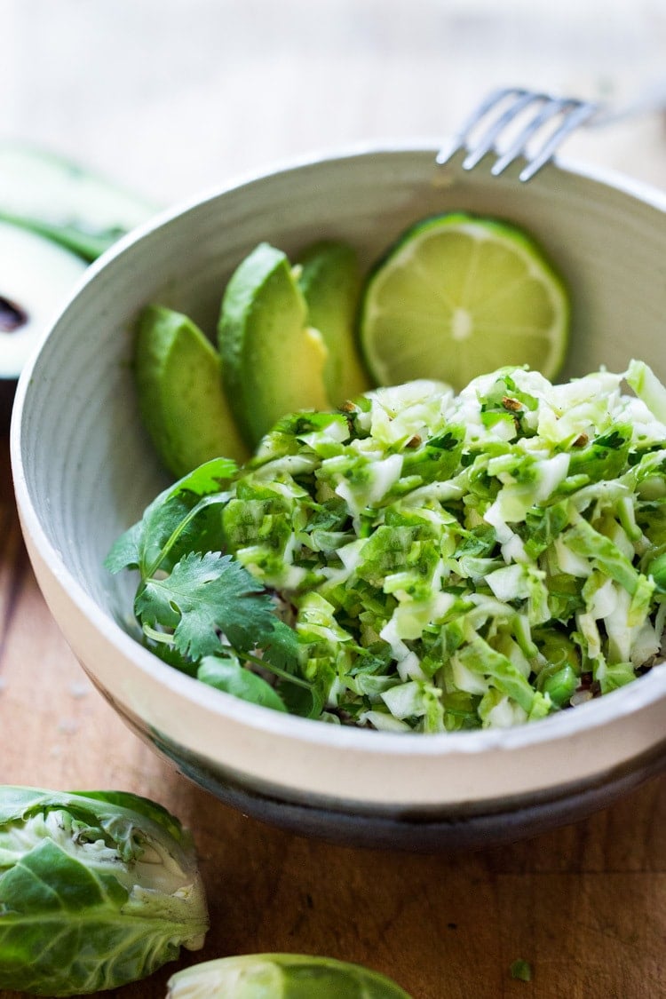 Vegan Mexican Brussel Sprout Salad with jalapeño, lime and cilantro! Serve as a "taco slaw",  a side salad for grill mains or meats. This salad can be made ahead! #brusselsproutsalad #brusslesproutslaw #brusselsprouts #veganslaw #vegansalad #mexicanslaw