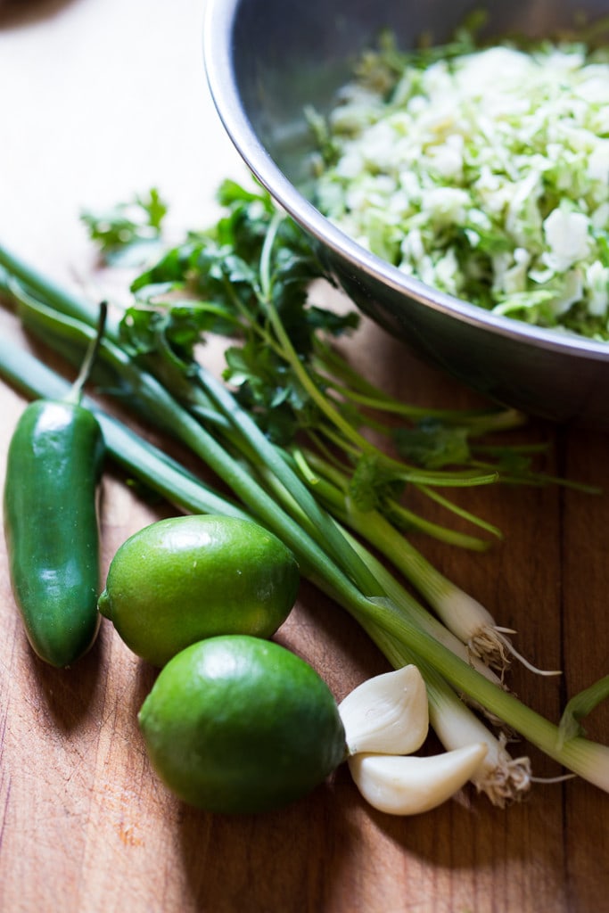 Vegan Mexican Brussel Sprout Salad with jalapeño, lime and cilantro! Serve as a "taco slaw",  a side salad for grill mains or meats. This salad can be made ahead! #brusselsproutsalad #brusslesproutslaw #brusselsprouts #veganslaw #vegansalad #mexicanslaw