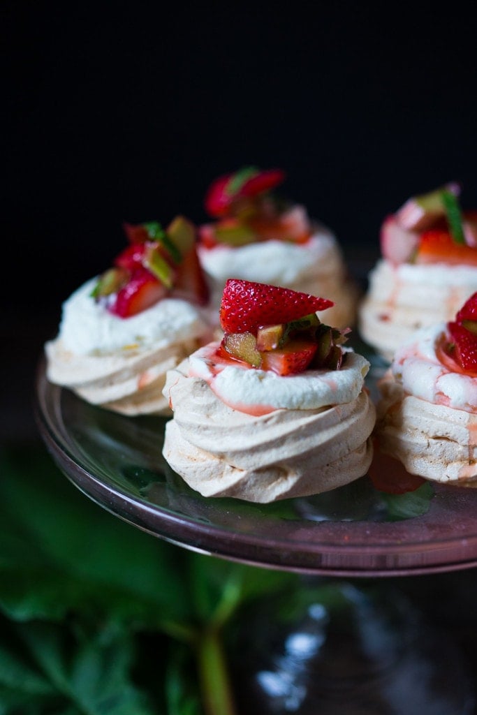 Mini Pavlova Recipe with strawberries, rhubarb and meyer lemon whipped cream! A light and airy dessert idea perfect for celebrations and gatherings. Can be made ahead!  #minipavlova #pavlova #dessert 