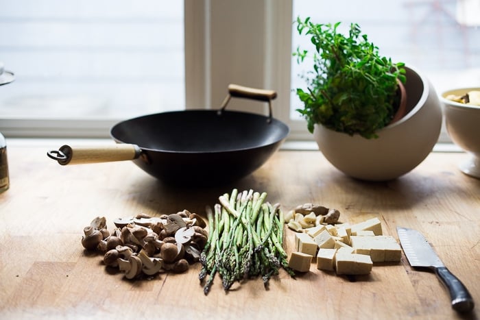 Wok seared asparagus and mushrooms with garlic, ginger and sesame...with crispy tofu- a vegan gluten free meal that can be made in 15 minutes flat! | www.feastingathome.com