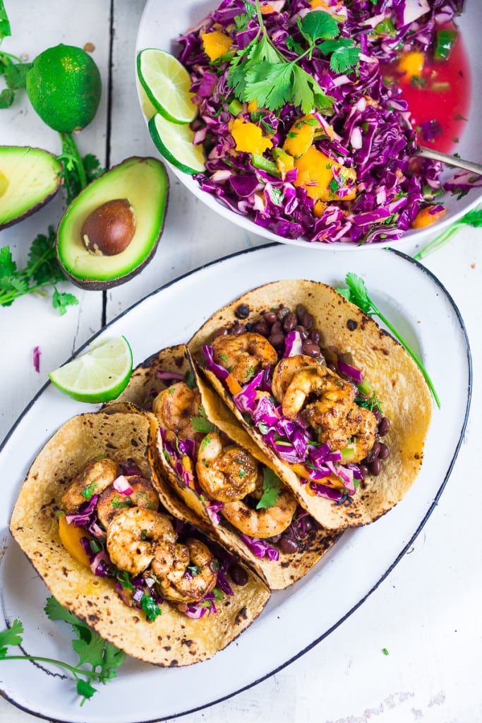 Caribbean Shrimp Tacos with a Mango Cabbage Slaw- bursting with Caribbean flavor! Healthy and can be made in 30 mins!| www.feastingathome.com 