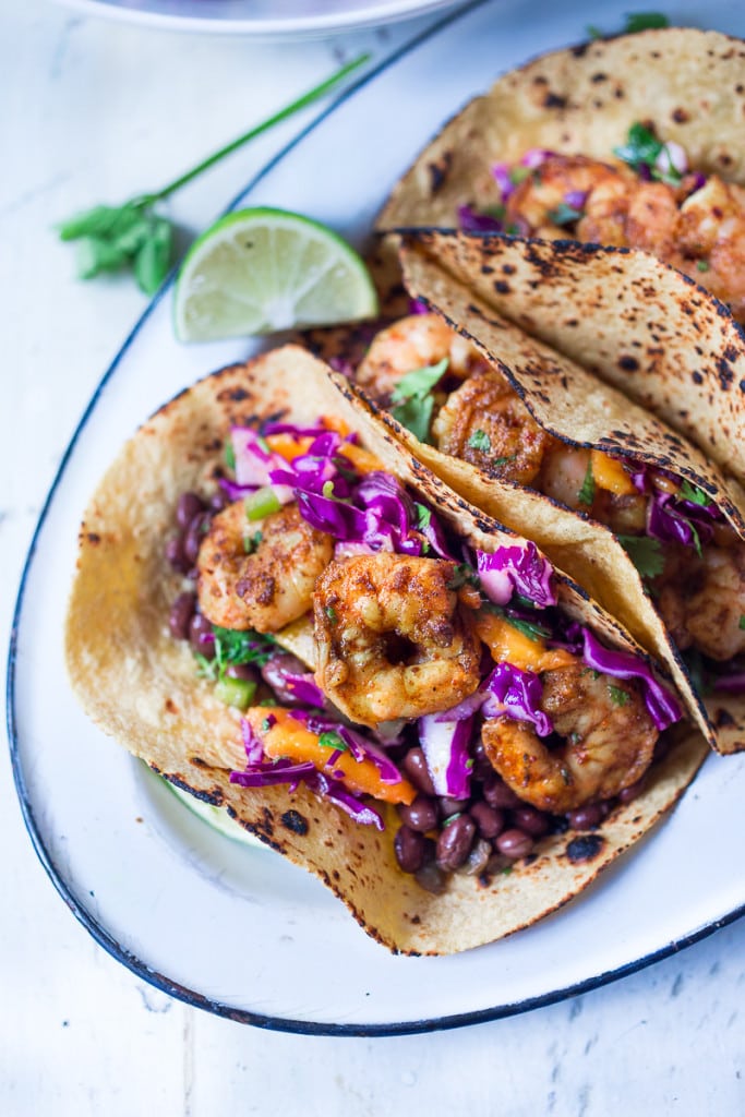 Caribbean Shrimp Tacos with a Mango Cabbage Slaw- bursting with Caribbean flavor! Healthy and can be made in 30 mins!| www.feastingathome.com 