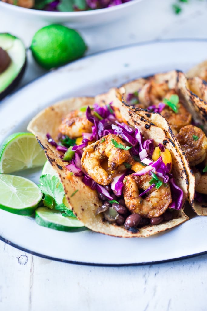 The BEST Shrimp Tacos with a Mango Cabbage Slaw- bursting with Caribbean flavors! Healthy, easy and fast- and can be made in 30 mins!| #shrimptacos #bestshrimptacos #shrimp #mango #cabbageslaw #tacos #mangosalad #blackbeantacos #prawntacos 