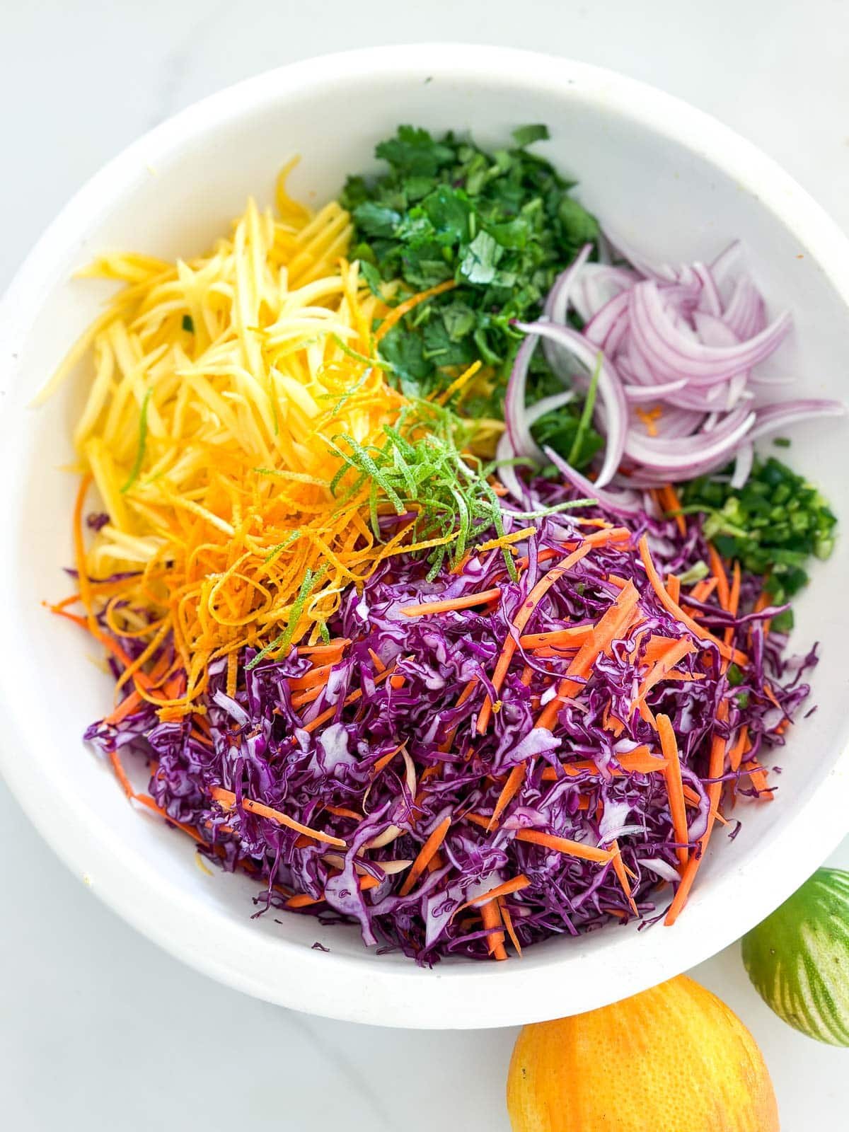 Mango slaw ingredients in a bowl.