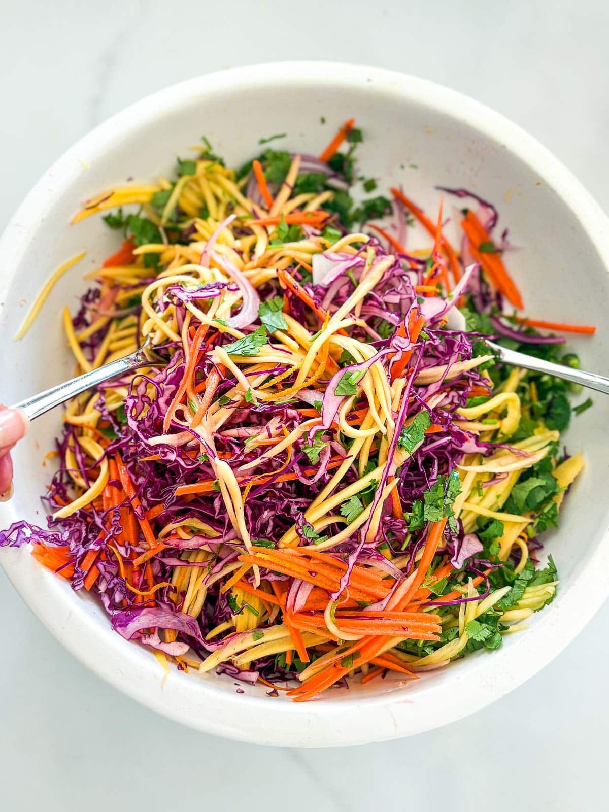 Tossing the Mango Salad.