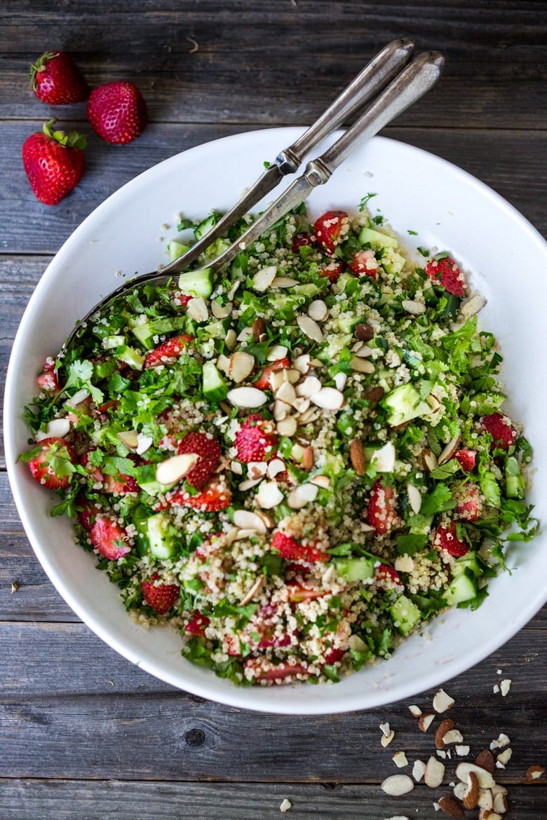 Delicious Strawberry Tabouli Salad - a twist on traditional tabouli, this spring-inspired version is made with quinoa, parsley, mint, and cucumber. Add avocado, toasted, slivered almonds, or feta if you like! #tabouli 