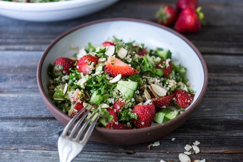 Delicious Strawberry Tabouli Salad - a twist on traditional tabouli, this spring-inspired version is made with quinoa, parsley, mint, and cucumber. Add avocado, toasted, slivered almonds, or feta if you like! #tabouli 