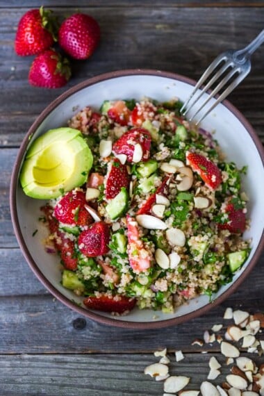 Delicious Strawberry Tabouli Salad - a twist on traditional tabouli, this spring-inspired version is made with quinoa, parsley, mint, and cucumber. Add avocado, toasted, slivered almonds, or feta if you like! #tabouli