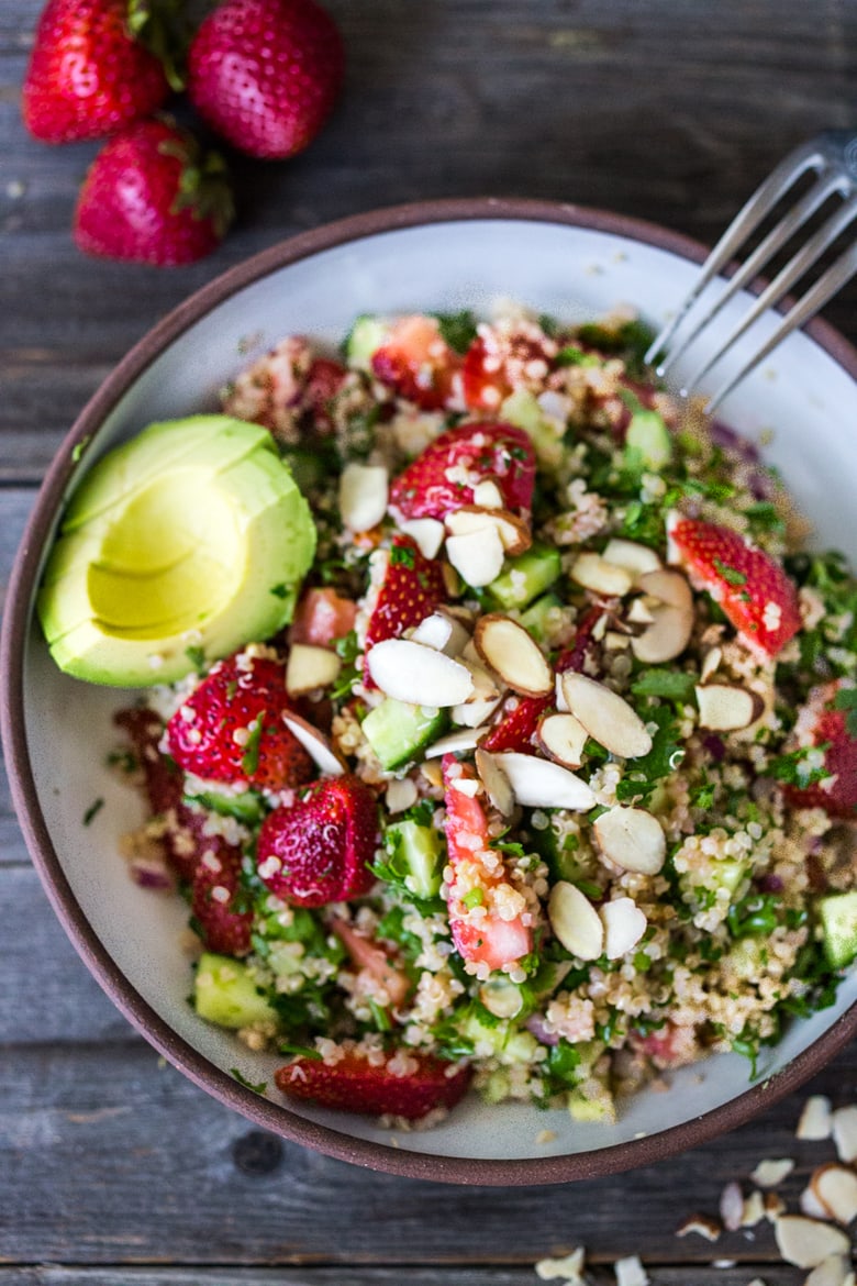 Delicious Strawberry Tabouli Salad - a twist on traditional tabouli, this spring-inspired version is made with quinoa, parsley, mint, and cucumber. Add avocado, toasted, slivered almonds, or feta if you like! #tabouli 