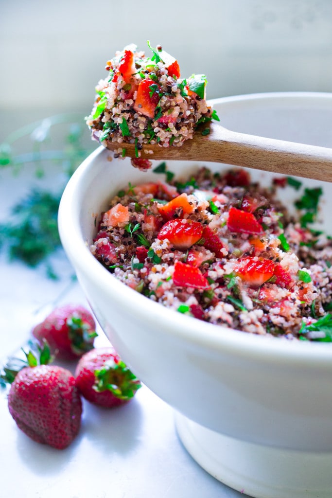 Delicious Strawberry Tabouli Salad - a twist on traditional tabouli, this spring-inspired version is made with quinoa, parsley, mint, and cucumber. Add avocado, toasted, slivered almonds, or feta if you like! #tabouli 