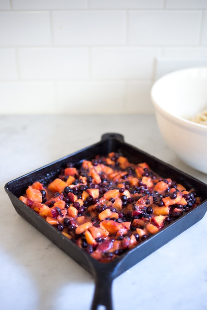 A summer Peach and Berry Skillet Cobbler with a crumbly golden biscuit topping. A simple scrumptious recipe! | www.feastingathome.com