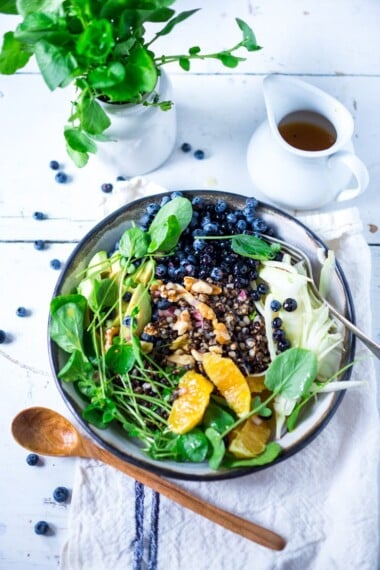 A healthy summer bowl packed full of nutrients for the skin- blueberries, avocado, walnuts, watercress, black nile barley with a bee pollen vinaigrette! | www.feastingathome.com