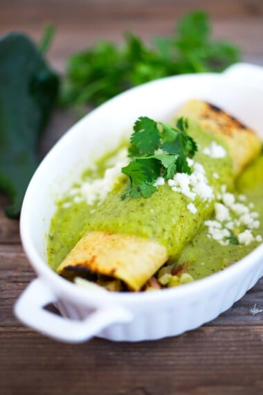 A delicious recipe for Green Enchiladas (Enchiladas Verde) slathered in Green Enchilada Sauce. Make it with chicken or keep it vegetarian!