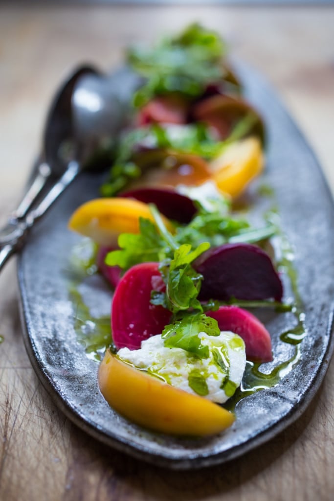 Creamy Burrata is paired with summer tomatoes, beets, and fresh basil- a delicious summery appetizer or salad, perfect for special gatherings.