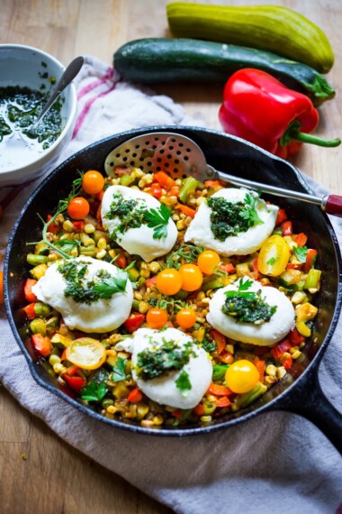 Breakfast Succotash with zucchini, corn and peppers, topped with poached eggs and a flavorful herb oil. | www.feastingathome.com