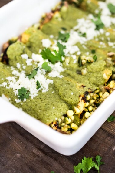 Enchiladas Verde! These Green Enchiladas are filled with fresh corn and roasted pobalno peppers with your choice or chicken or blackbeans. They are slathered in the tastiest homemade Green Enchilada Sauce! Easy and full of flavor! #enchiladas #enchiladasverde