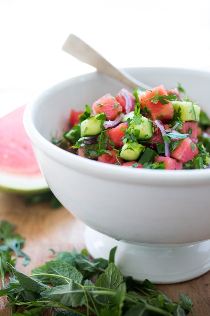 A Moroccan Watermelon Salad with Cucumber, pistachios, parsley, mint, onion and crumbled feta...refreshing, simple and delicious! | www.feastingathome.com