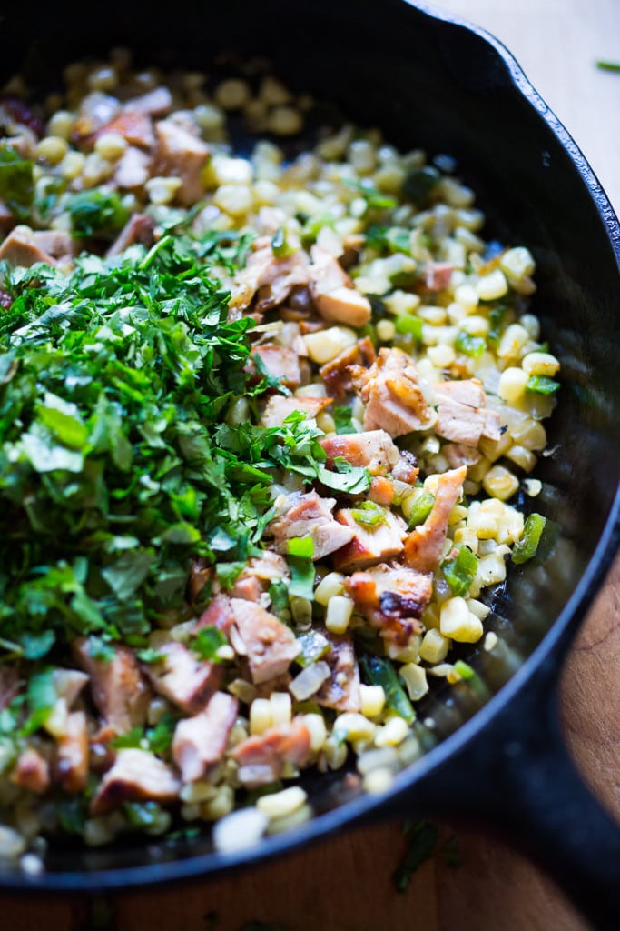 Smoked Chicken Enchiladas with sweet corn, poblanos and a vibrant flavorful Tomatillo sauce. | www.feastingathome.com