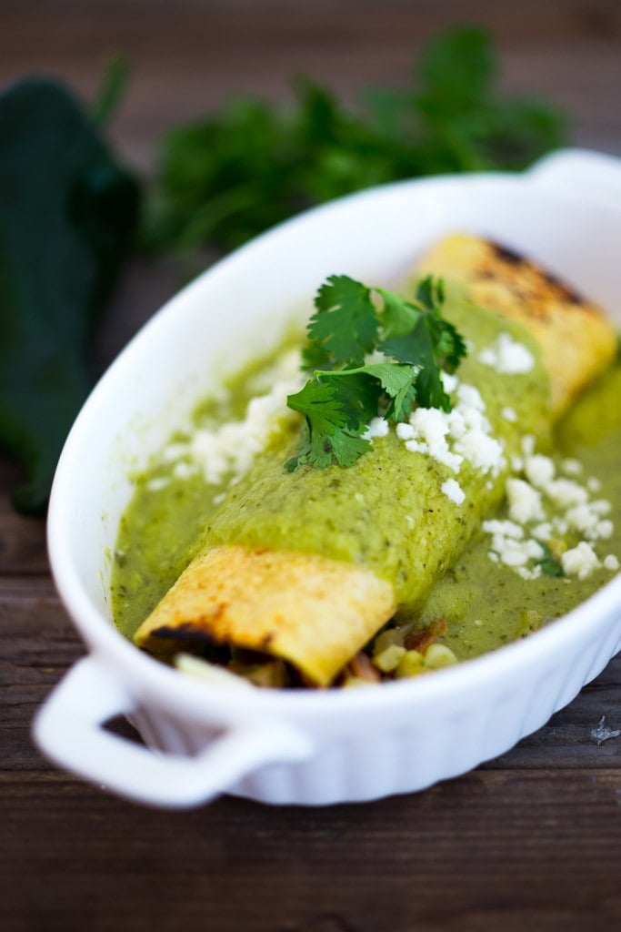 Enchiladas Verde! These Green Enchiladas are filled with fresh corn and roasted pobalno peppers with your choice or chicken or blackbeans. They are slathered in the tastiest homemade Green Enchilada Sauce! Easy and full of flavor! #enchiladas #enchiladasverde