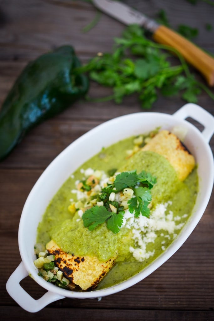 Enchiladas Verde with Corn, Chicken (or Black beans) and Roasted Poblano Sauce. A simple healthy Mexican inspired meal that is easy and flavorful! #enchiladasverde #greenenchiladas #enchiladas #poblanosauce #greensauce #mexicangreensauce #tomatillosauce 