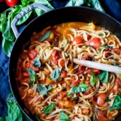 Spaghetti and fresh pasta sauce in a pan.