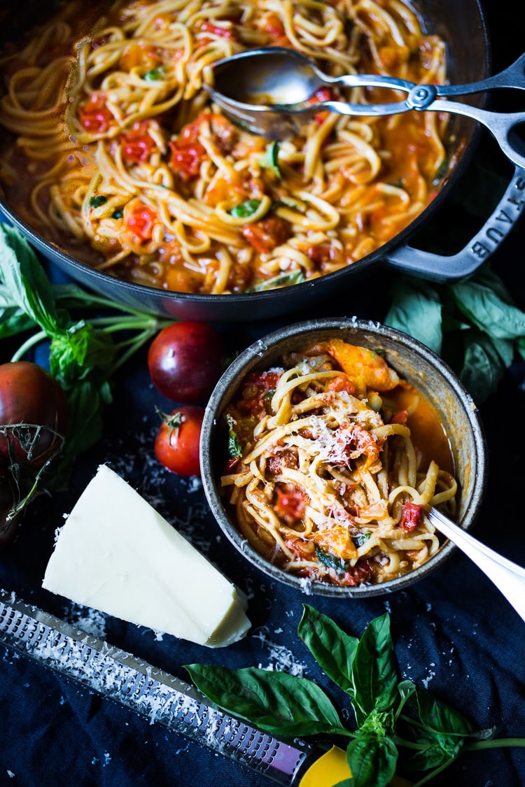 A bowls of Spaghetti with Fresh Tomato Sauce and Basil topped with grated pecorino cheese.