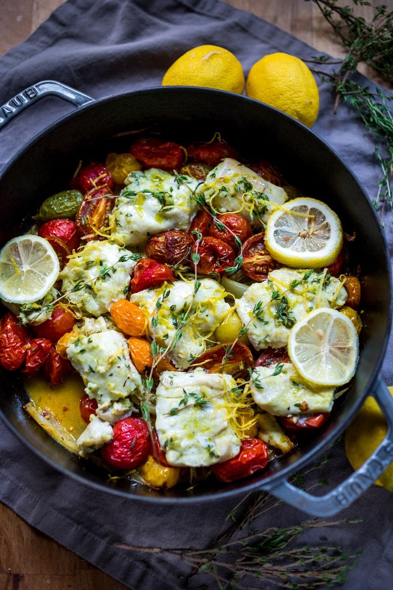 Baked haddock ( or any white fish) with roasted tomatoes , fennel, garlic, lemon and thyme. A healthy, easy one pot meal that can be made in about 35 minutes! www.feastingathome.com