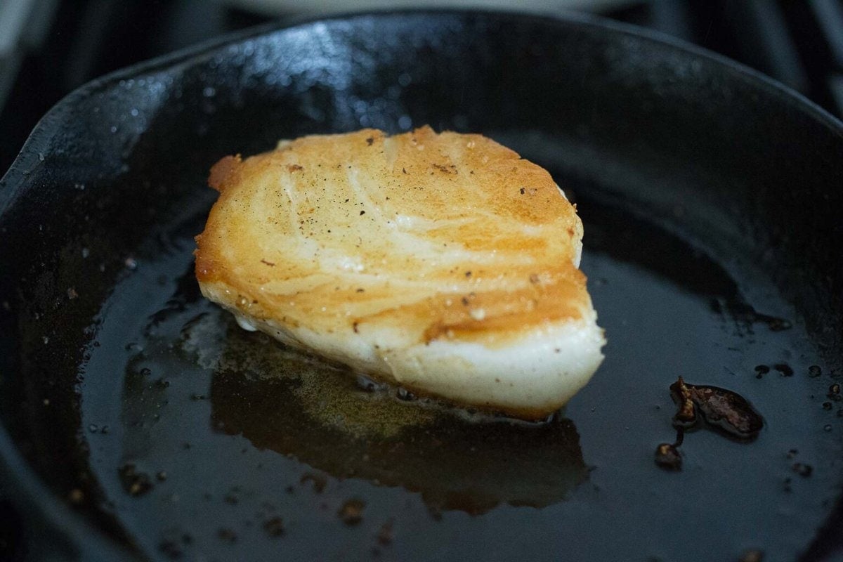 searing a piece of halibut.