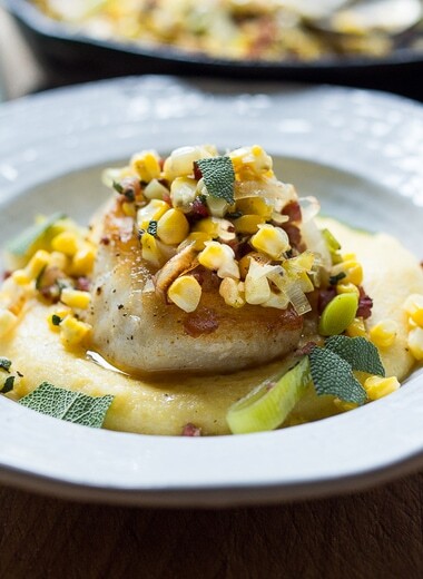 A delicious recipe for seared Halibut, featuring fresh summer corn, leeks, sage and optional pancetta served over creamy polenta.