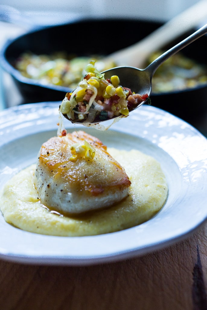 A simple delicious recipe for Halibut with corn, pancetta and sage, served over a "lightened-up" creamy polenta. And the best part is it can be made un under 30 minutes! | www.feastingathome.com